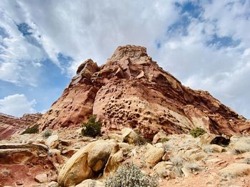 Low angle view of rock formation against sky