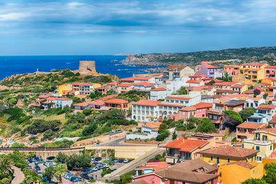 High angle view of townscape by sea against sky