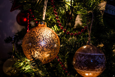 Close-up of ornaments hanging on christmas tree