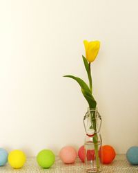 Close-up of colorful decorative balls with flower vase