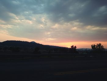 Scenic view of silhouette landscape against sky at sunset