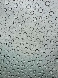A shot of raindrops on a sunroof