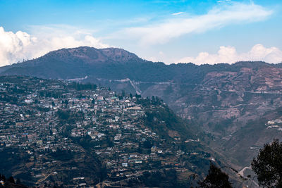 City urbanization view from hilltop with huge construction and dramatic sky