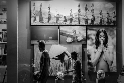 Portrait of people looking through glass window