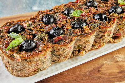 Eggplant pie with tomato sauce and olives. french gourmet cuisine