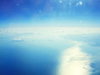 Aerial view of sea against blue sky