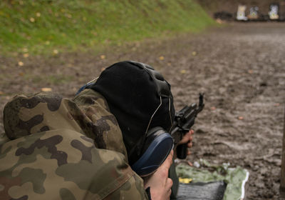 Close-up of soldier aiming rifle