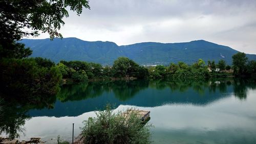 Scenic view of lake and mountains against sky