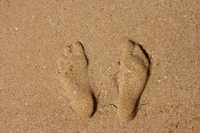 Close-up of footprints on sand