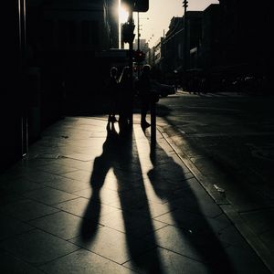 Shadow of people on city street