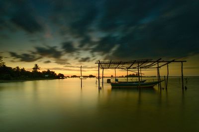 Sailboats in sea against sky during sunset