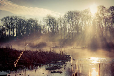 Scenic view of lake against sky during winter