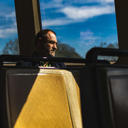 Portrait of man sitting in car window