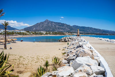 Scenic view of beach against blue sky