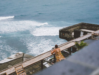 High angle view of railing by sea