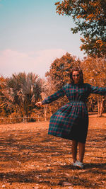 Rear view of woman standing on field