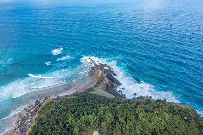 Byron bay australia. scenic view ocean beach patterned waves with white foam. travel and recreation.