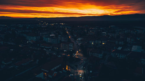 High angle view of illuminated buildings against sky at sunset