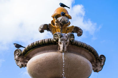 Low angle view of statue against sky