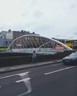 Rear view of person walking on bridge