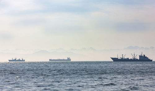 Large fishing vessel on the background of hills and volcanoes