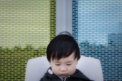 Close-up of cute boy against window