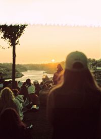 Rear view of people at sunset