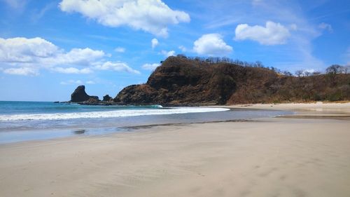 View of beach against cloudy sky