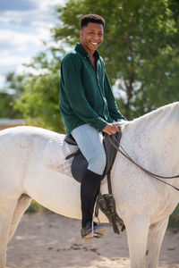 Portrait of smiling man riding horse