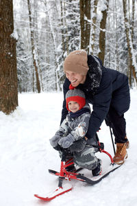 Young man skiing on snow covered field