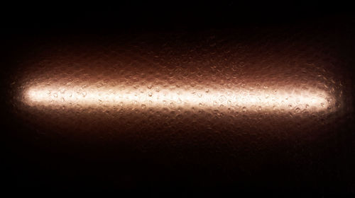 Abstract image of illuminated metal at night