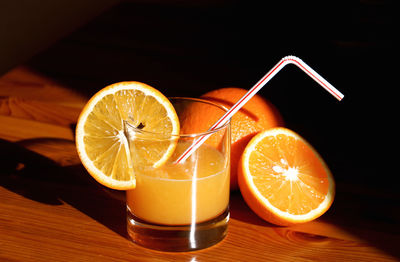 Close-up of orange drink in glass on table