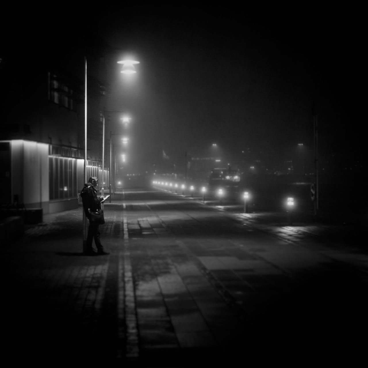 MAN WALKING ON ROAD AT NIGHT