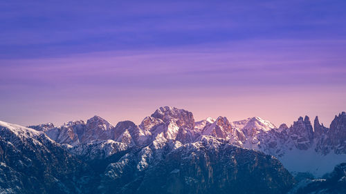 Scenic view of snowcapped mountains against sky during sunset