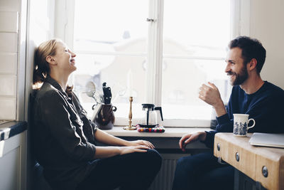 Young couple looking at window