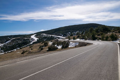 Curved road towards the snowy mountain