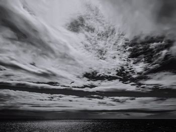 Scenic view of sea against dramatic sky