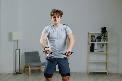 Portrait of young man standing in gym
