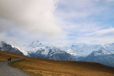 Scenic view of mountains against cloudy sky