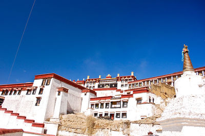 Low angle view of buildings against blue sky