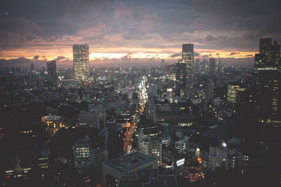 High angle view of illuminated buildings against sky at night