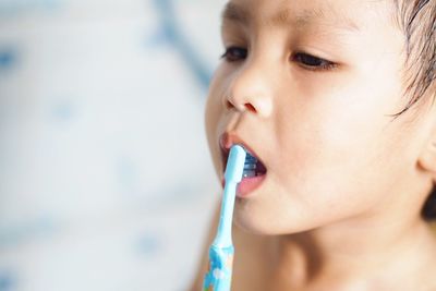 Close-up of cute boy brushing teeth