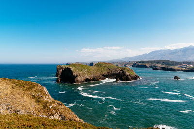 Scenic view of sea against blue sky