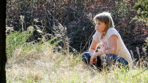 Young woman sitting on grass