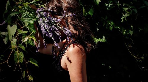 Midsection of woman standing on plant