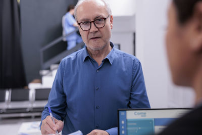 Side view of man working at office