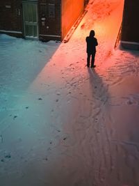 Silhouette of man walking on road