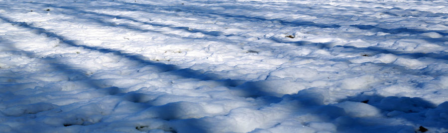 High angle view of snow on blue sky