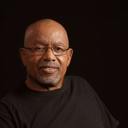 Portrait of smiling mature man against black background