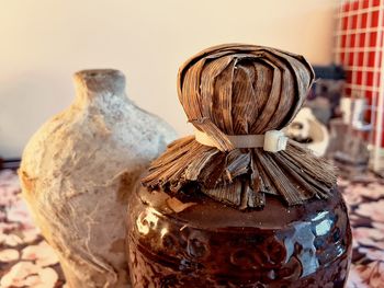 Close-up of carving on table against wall